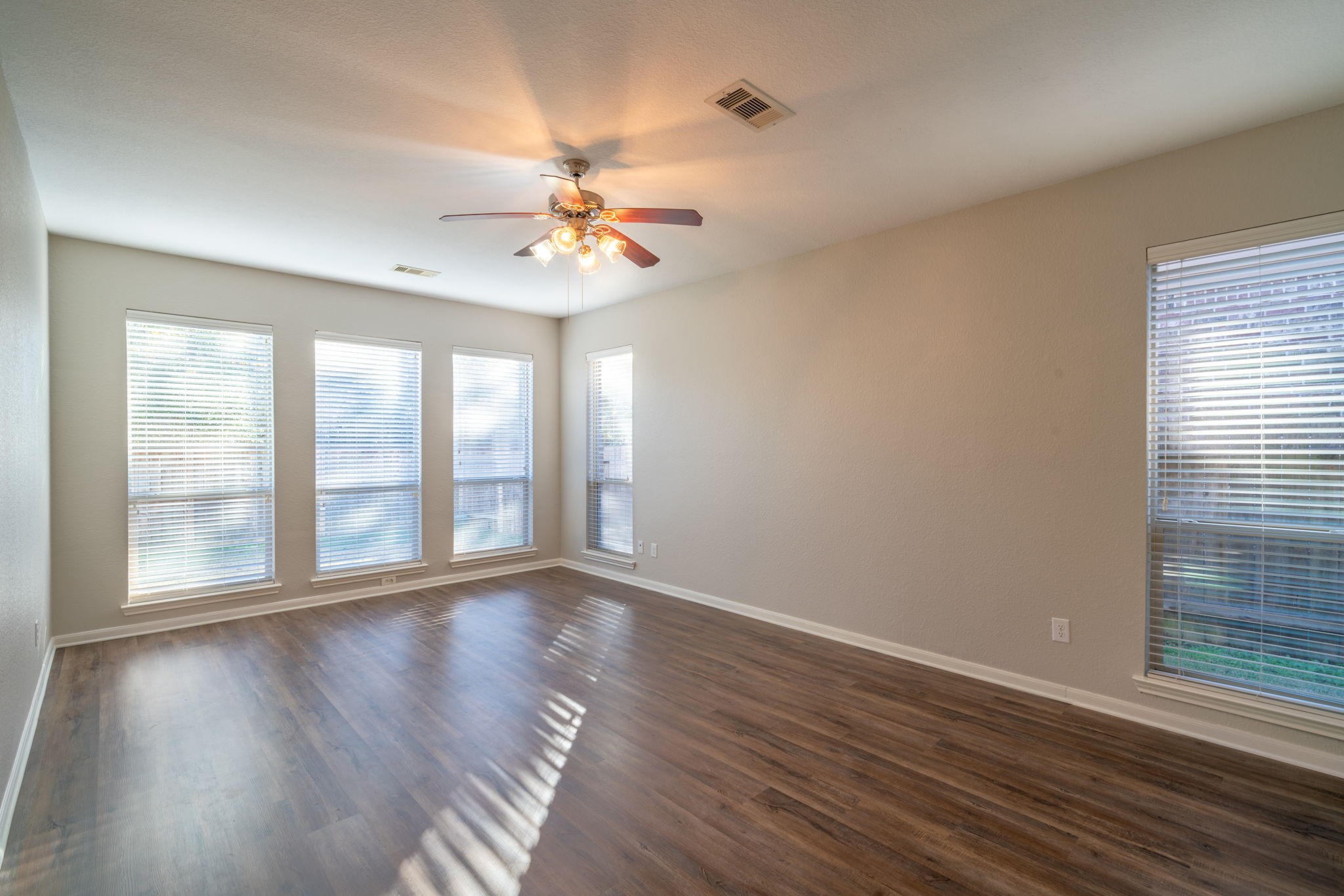 138 Magnolia Grove Lane Conroe, TX 77384 - Photo 19 of 43 a view of an empty room with a window and wooden floor