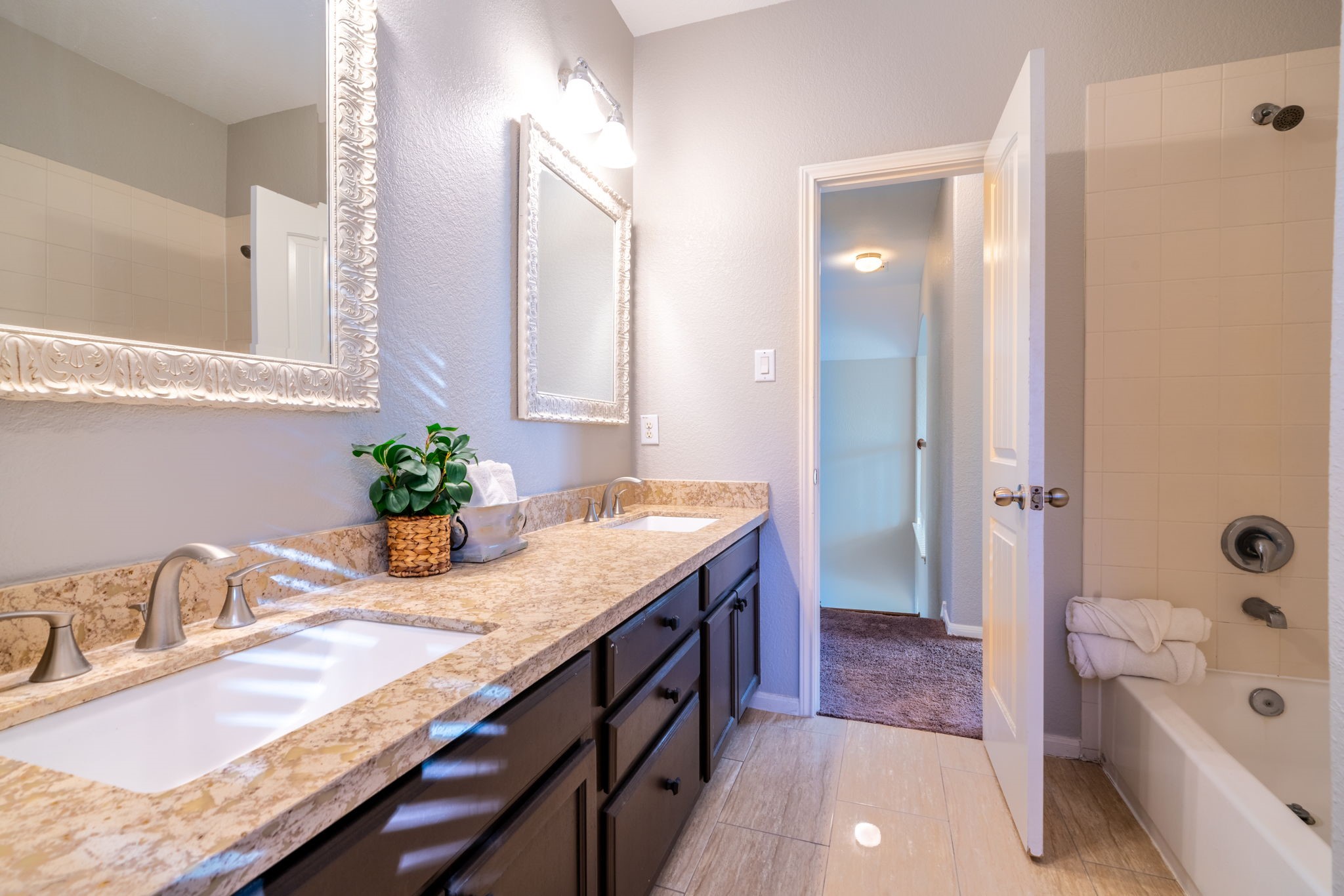 138 Magnolia Grove Lane Conroe, TX 77384 - Photo 25 of 43 a bathroom with a granite countertop sink a mirror a bathtub and shower