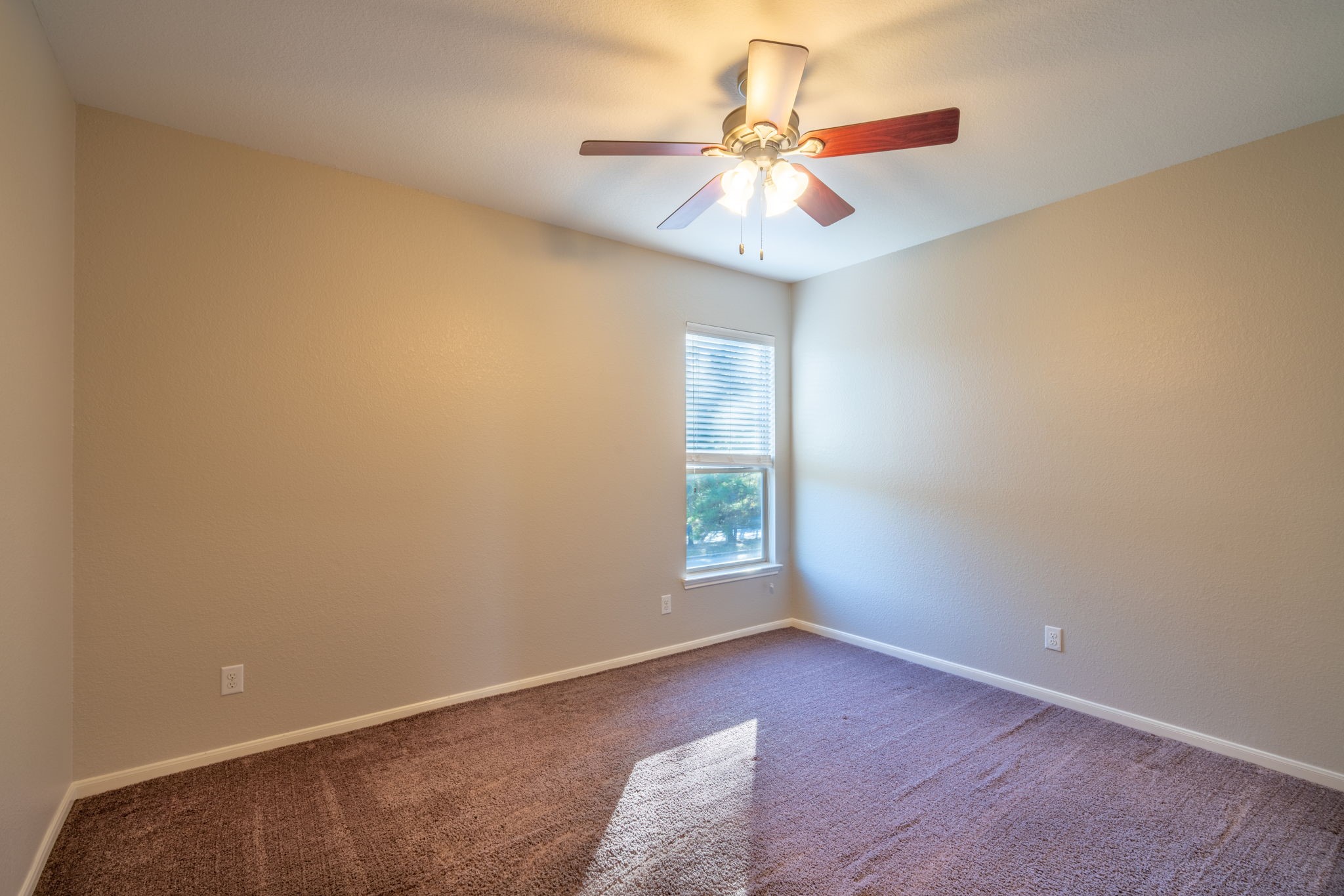 138 Magnolia Grove Lane Conroe, TX 77384 - Photo 30 of 43 an empty room with a chandelier fan and windows
