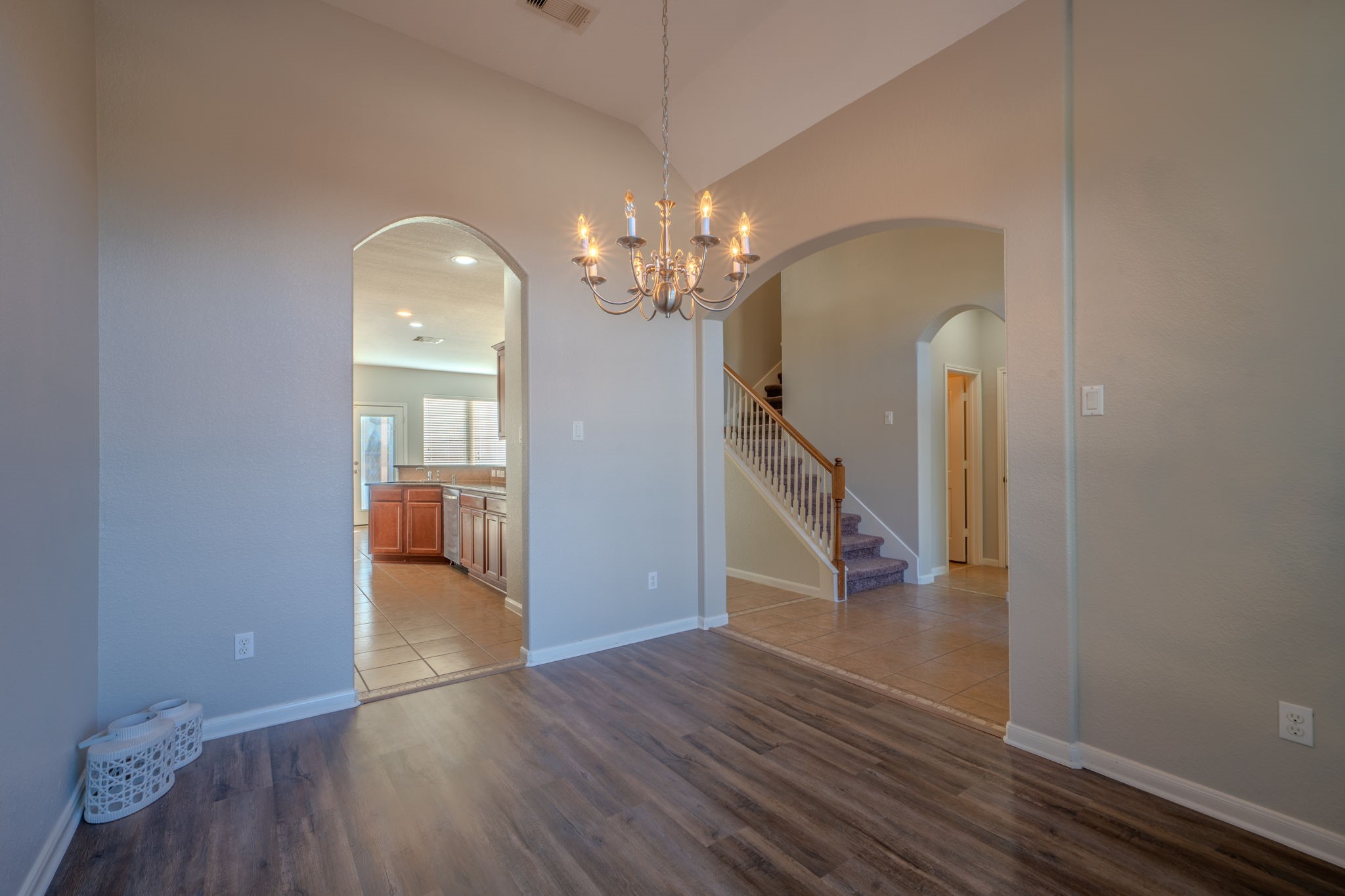 138 Magnolia Grove Lane Conroe, TX 77384 - Photo 6 of 43 a view of a room with wooden floor staircase and a living room