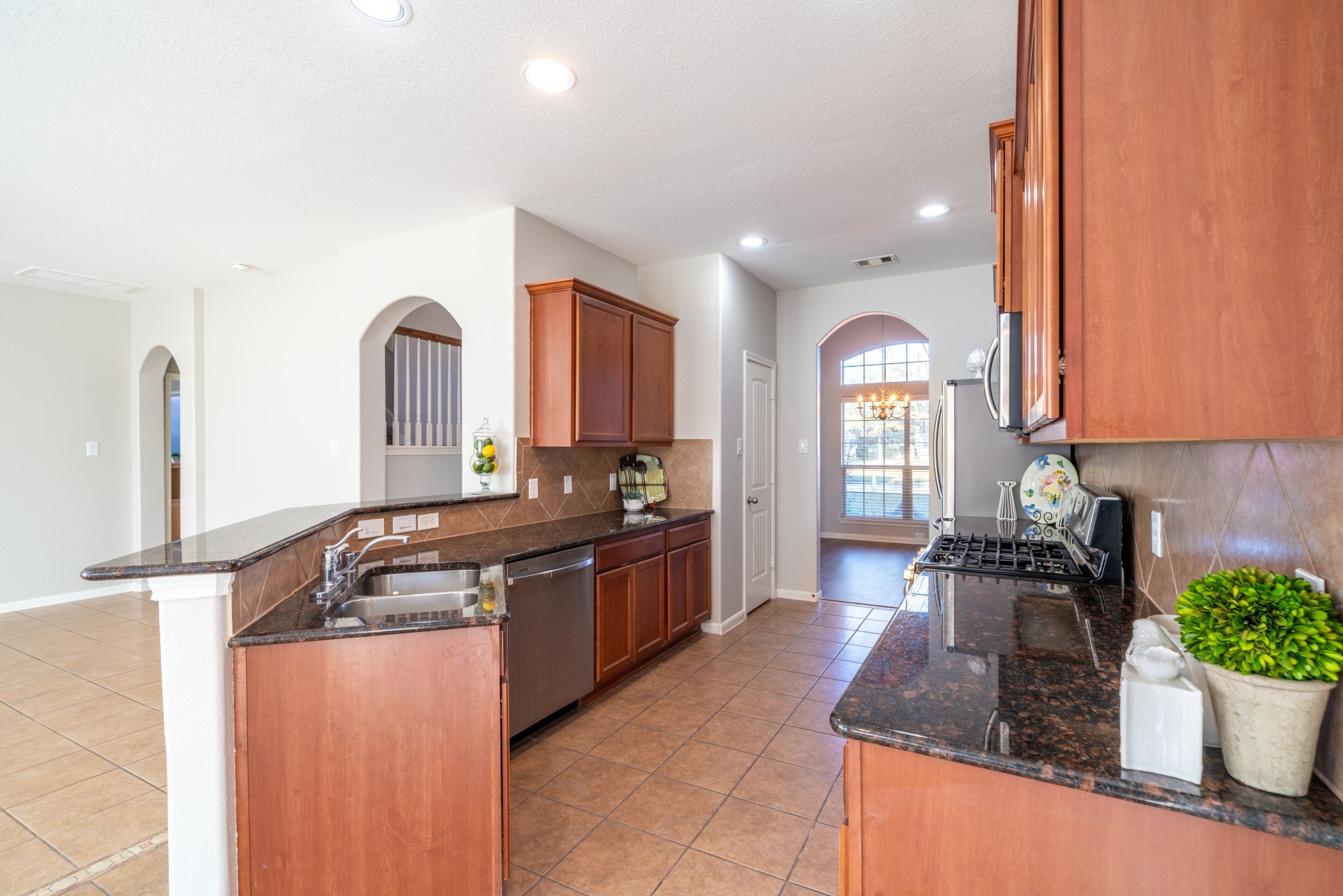 138 Magnolia Grove Lane Conroe, TX 77384 - Photo 9 of 43 a kitchen with stainless steel appliances granite countertop a sink a stove and a wooden floors