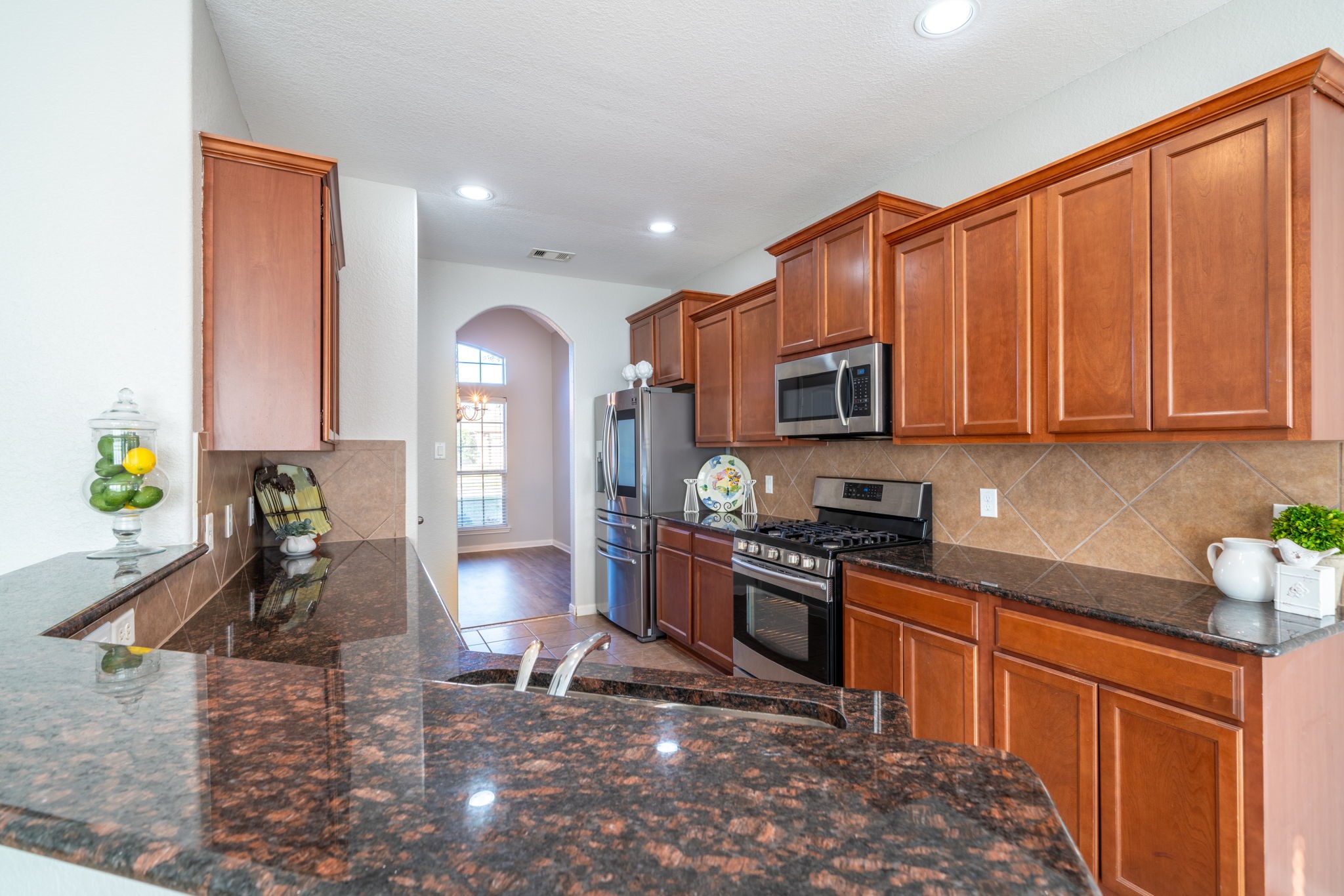 138 Magnolia Grove Lane Conroe, TX 77384 - Photo 10 of 43 a kitchen with stainless steel appliances granite countertop a sink stove and cabinets