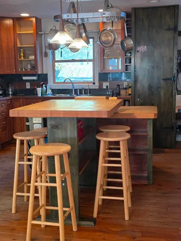 a room with a stove a sink and a window