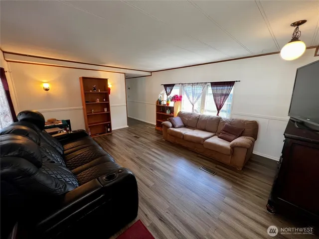 a living room with furniture window and wooden floor