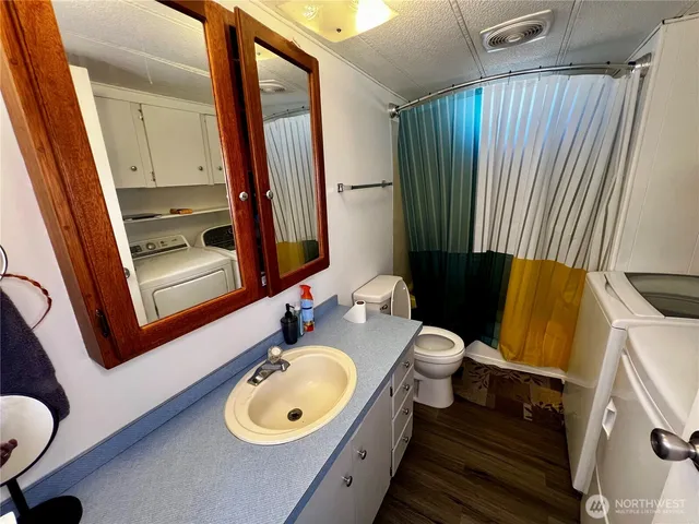 a bathroom with a sink toilet and tub