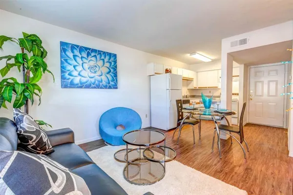 a living room with furniture and a potted plant