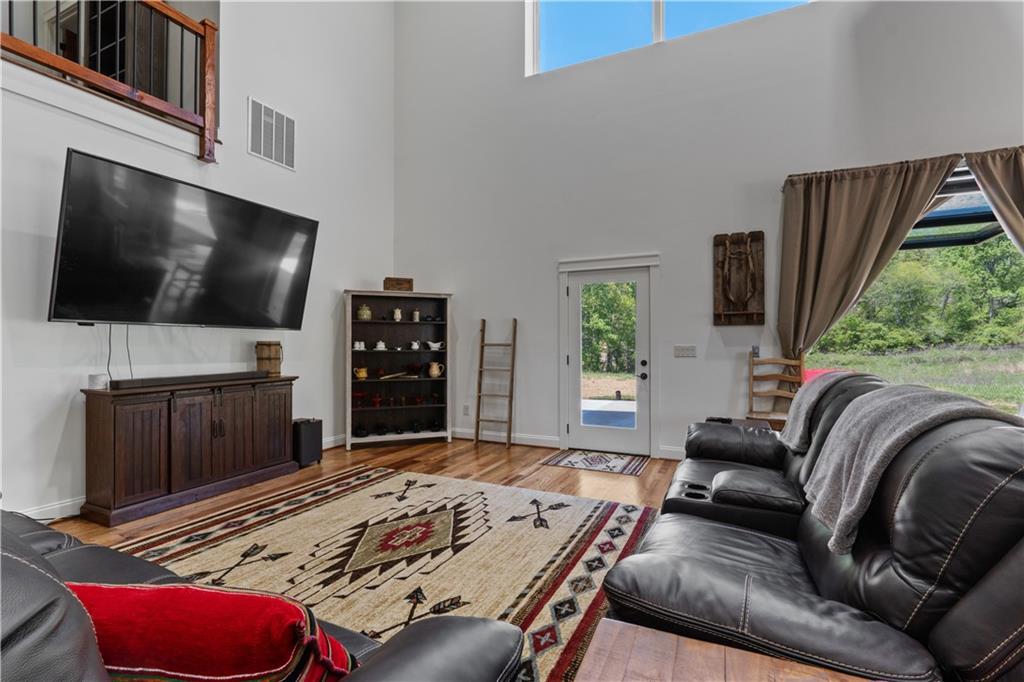 1590 4 Mile Church Road Ball Ground, GA 30107 - Photo 16 of 65 a living room with furniture and a flat screen tv