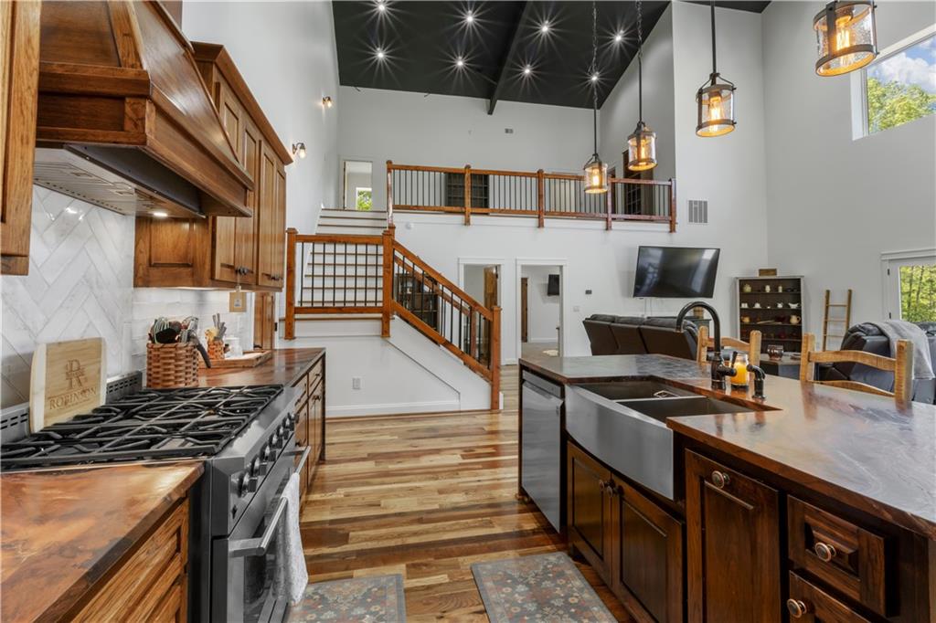 1590 4 Mile Church Road Ball Ground, GA 30107 - Photo 26 of 65 a kitchen with stainless steel appliances granite countertop a stove and a sink