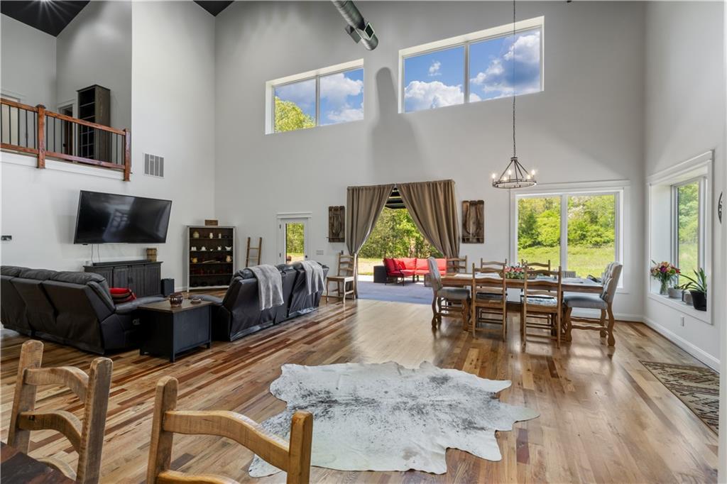 1590 4 Mile Church Road Ball Ground, GA 30107 - Photo 30 of 65 a living room with furniture a flat screen tv and a large window