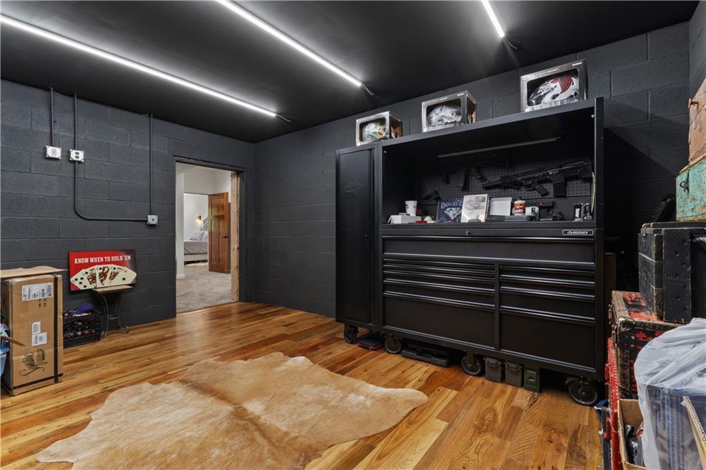 1590 4 Mile Church Road Ball Ground, GA 30107 - Photo 42 of 65 a bedroom with bed and a walk in closet