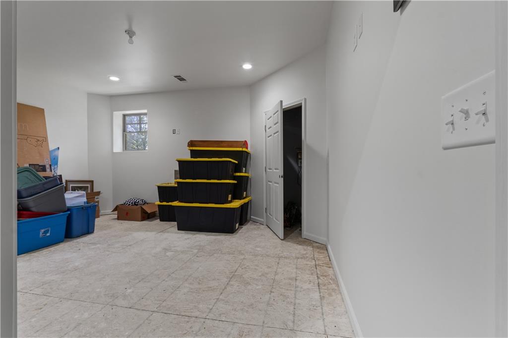 1590 4 Mile Church Road Ball Ground, GA 30107 - Photo 56 of 65 a living room with furniture and a flat screen tv