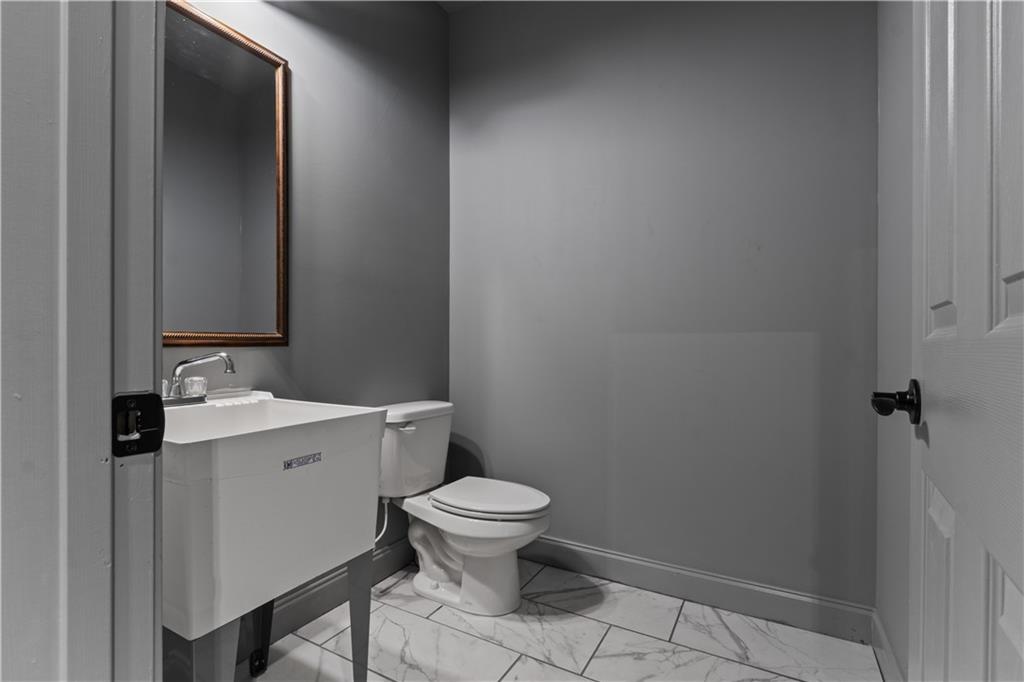 1590 4 Mile Church Road Ball Ground, GA 30107 - Photo 60 of 65 a bathroom with a toilet a sink and mirror