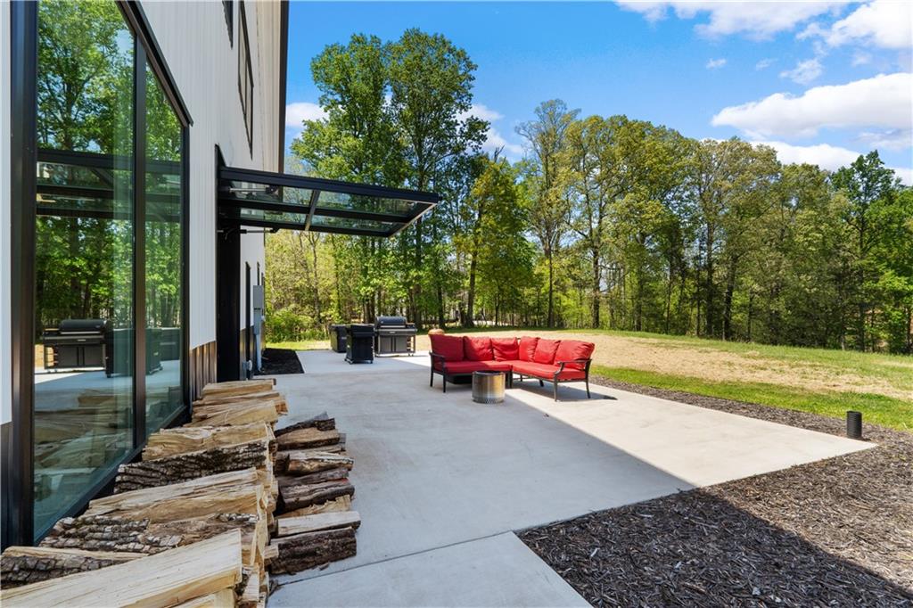 1590 4 Mile Church Road Ball Ground, GA 30107 - Photo 7 of 65 a view of outdoor space with seating area and trees in the back