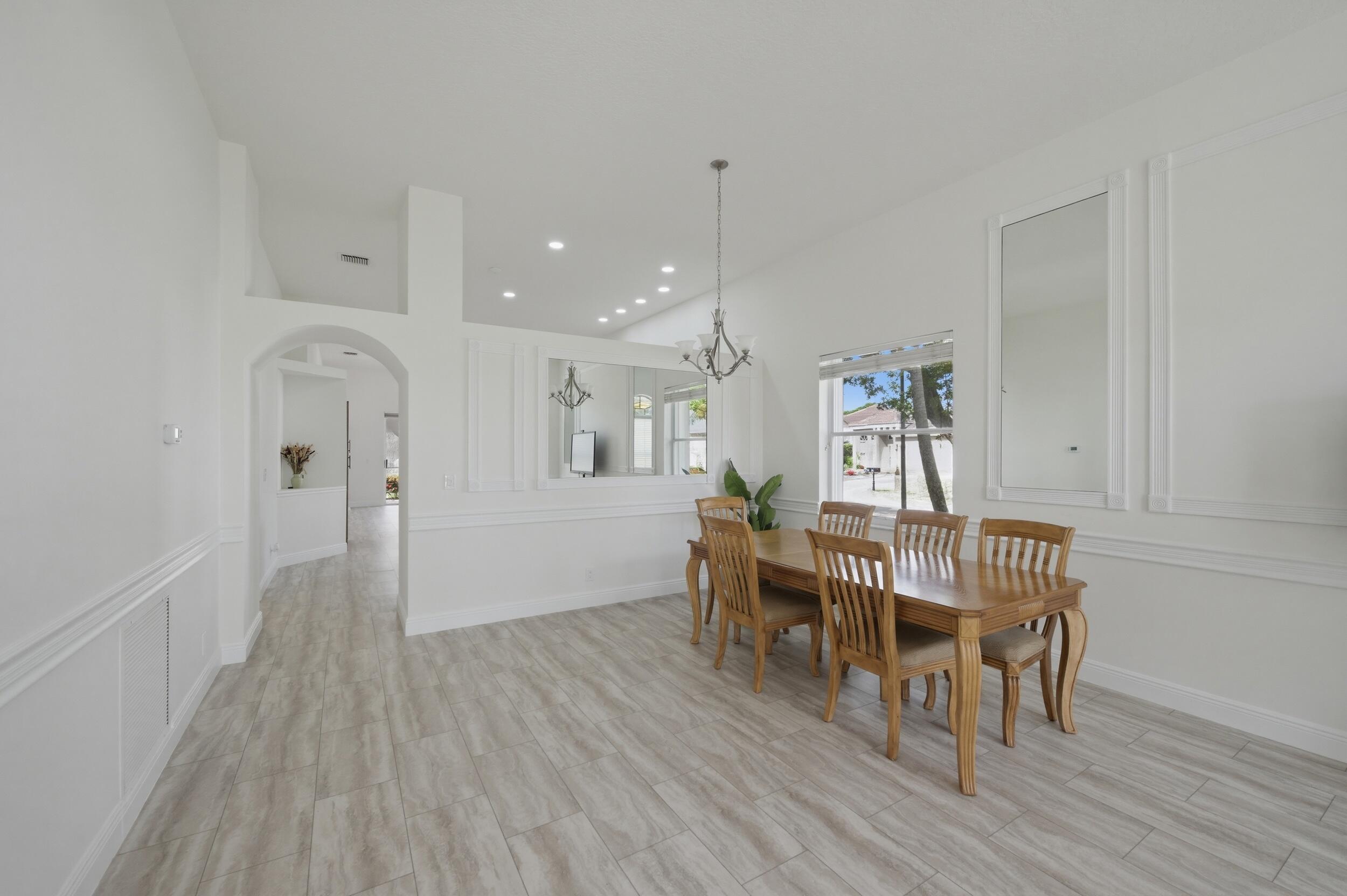8534 Vía D Oro Boca Raton, FL 33433 - Photo 6 of 34 a view of a dining room with furniture and wooden floor