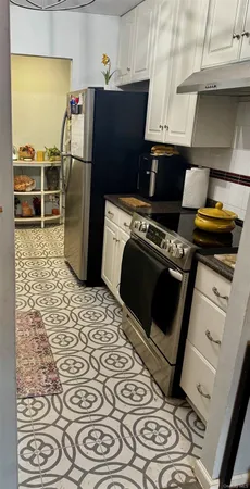 a kitchen with stainless steel appliances granite countertop a stove and a sink