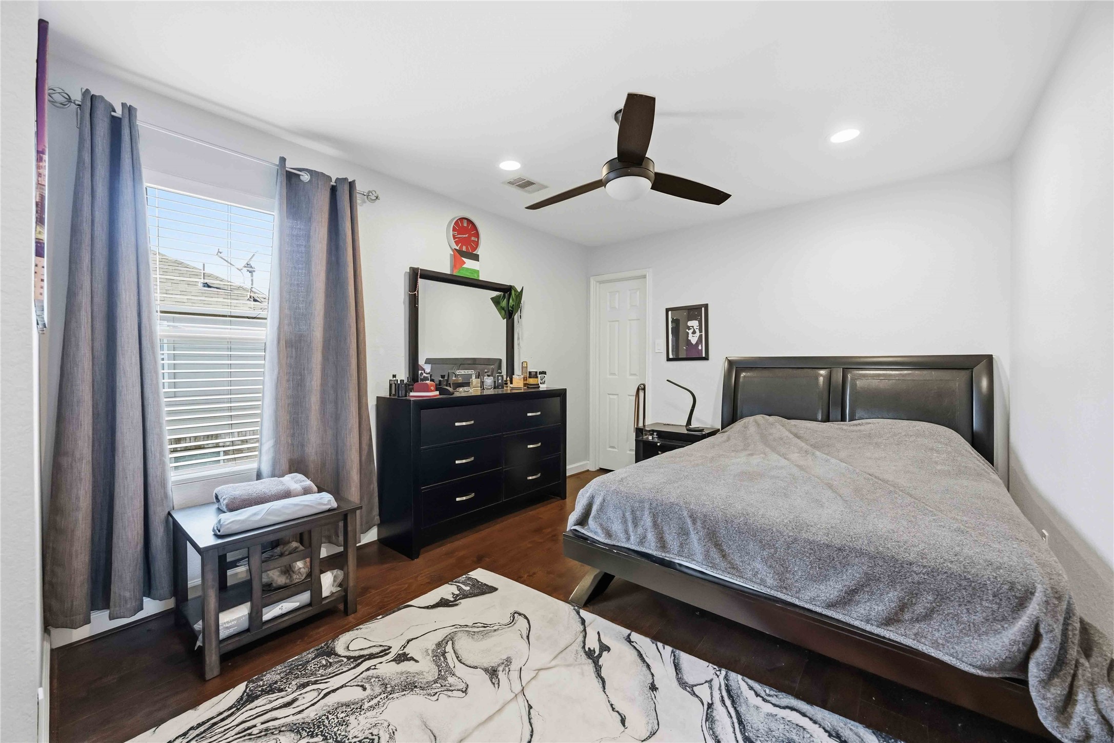 19219 Brook Village Road Houston, TX 77084 - Photo 13 of 29 a bedroom with a bed and wooden floor