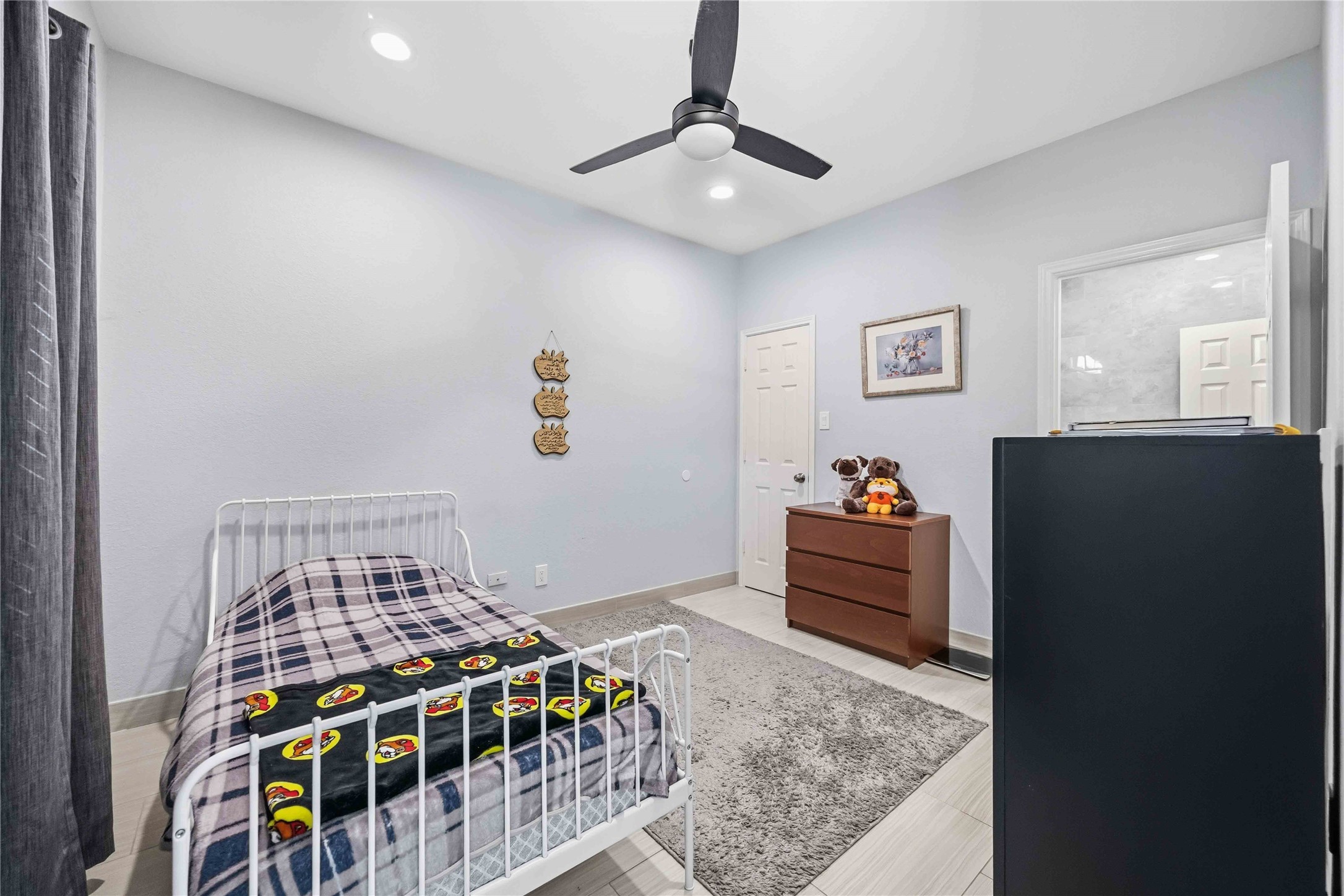 19219 Brook Village Road Houston, TX 77084 - Photo 14 of 29 a bedroom with furniture and window