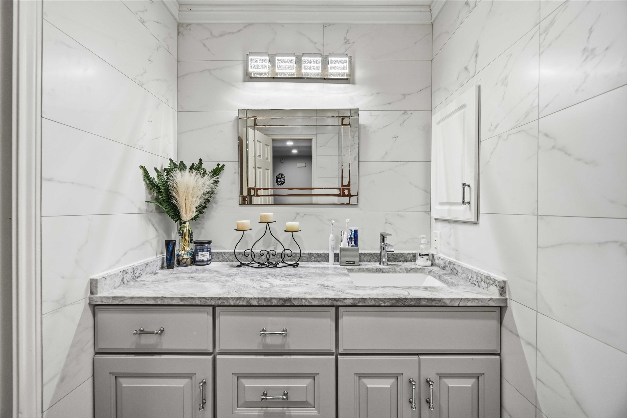 19219 Brook Village Road Houston, TX 77084 - Photo 16 of 29 a bathroom with a granite countertop sink a mirror and cabinets