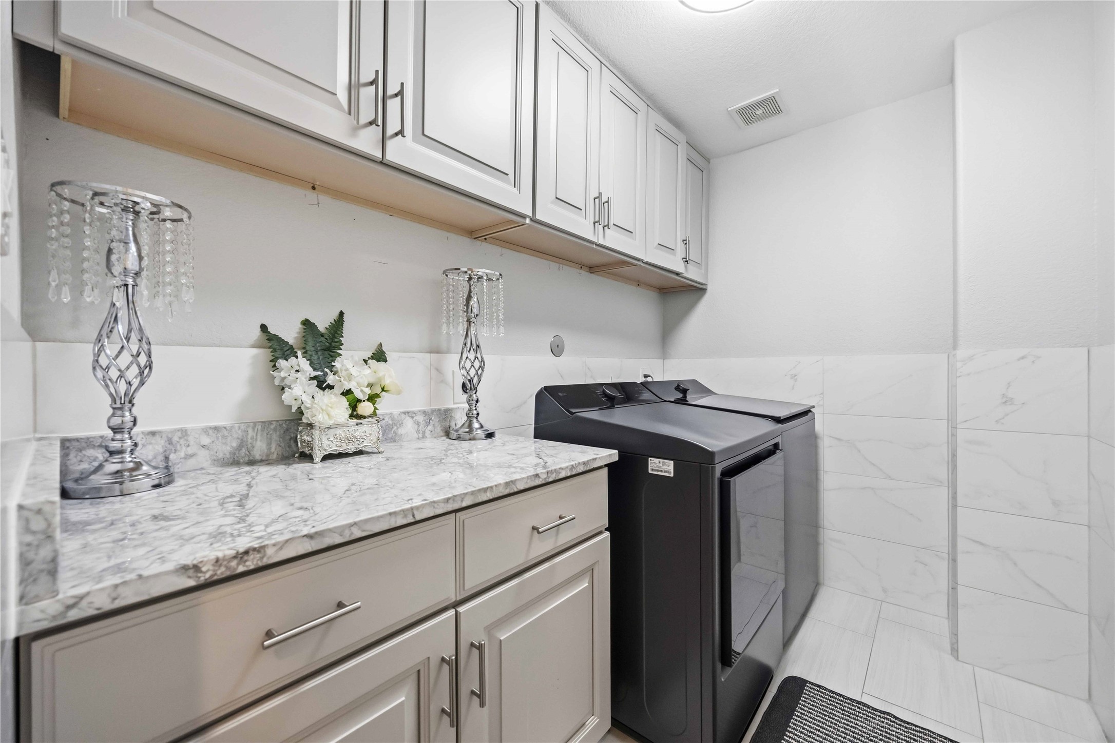 19219 Brook Village Road Houston, TX 77084 - Photo 19 of 29 a sink with cabinets and wooden floor
