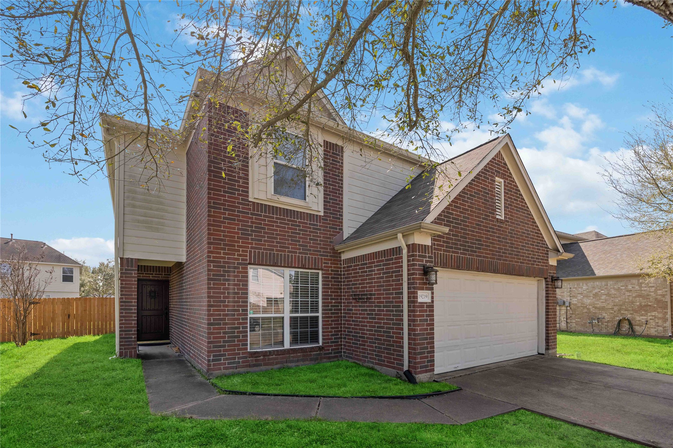 19219 Brook Village Road Houston, TX 77084 - Photo 2 of 29 a view of a house with a yard