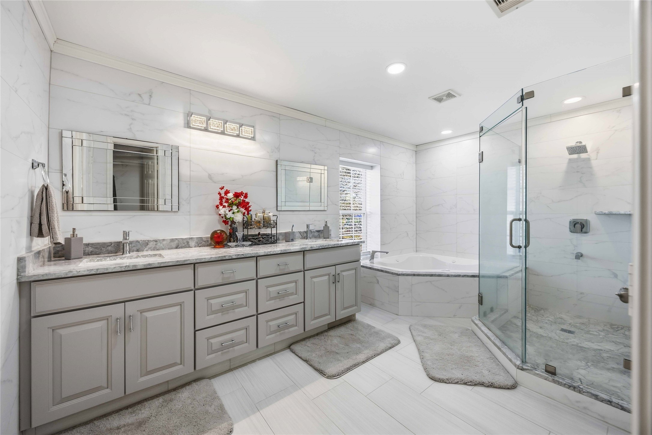 19219 Brook Village Road Houston, TX 77084 - Photo 22 of 29 a spacious bathroom with a granite countertop sink mirror and a shower