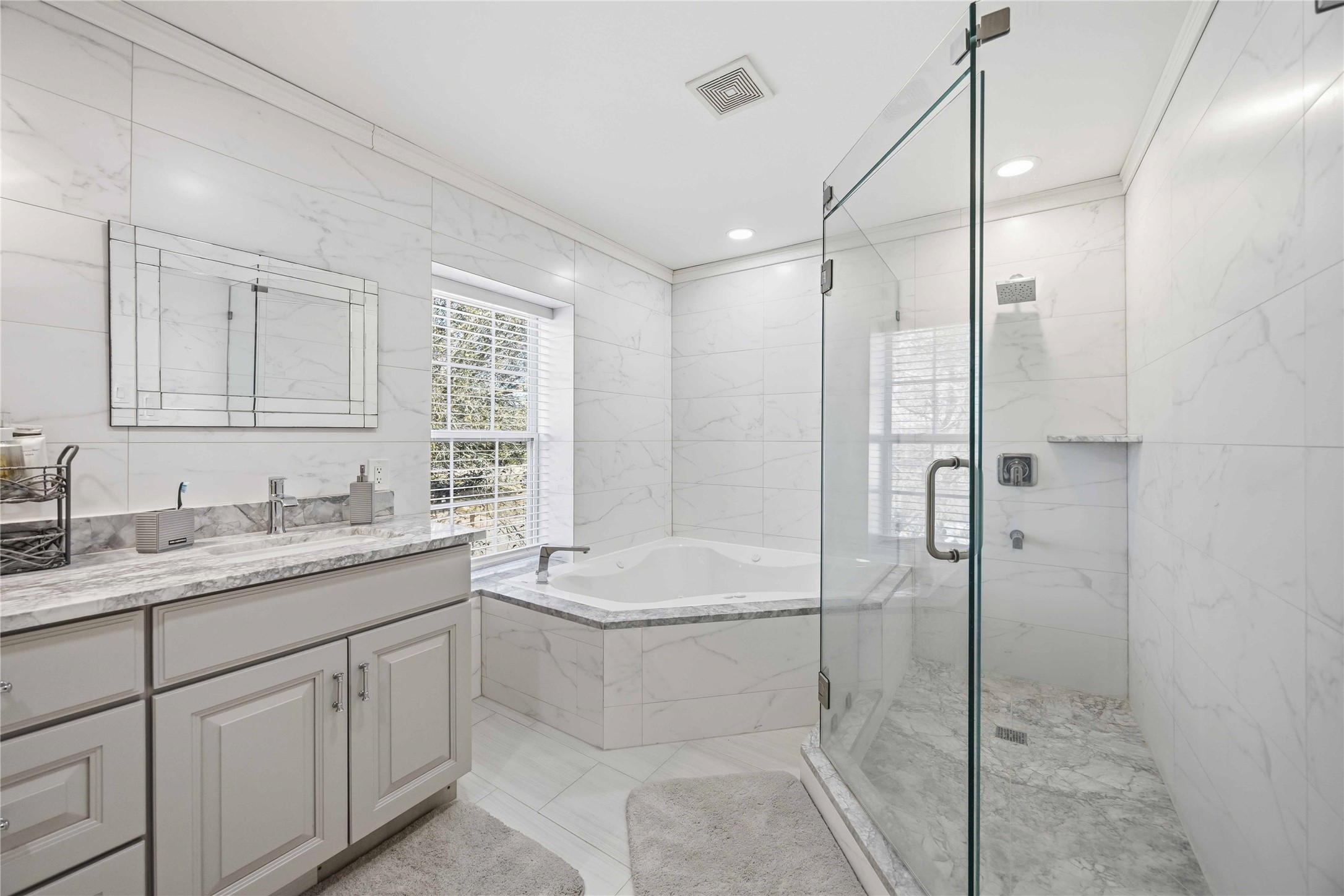 19219 Brook Village Road Houston, TX 77084 - Photo 23 of 29 a bathroom with a granite countertop sink mirror bathtub and shower