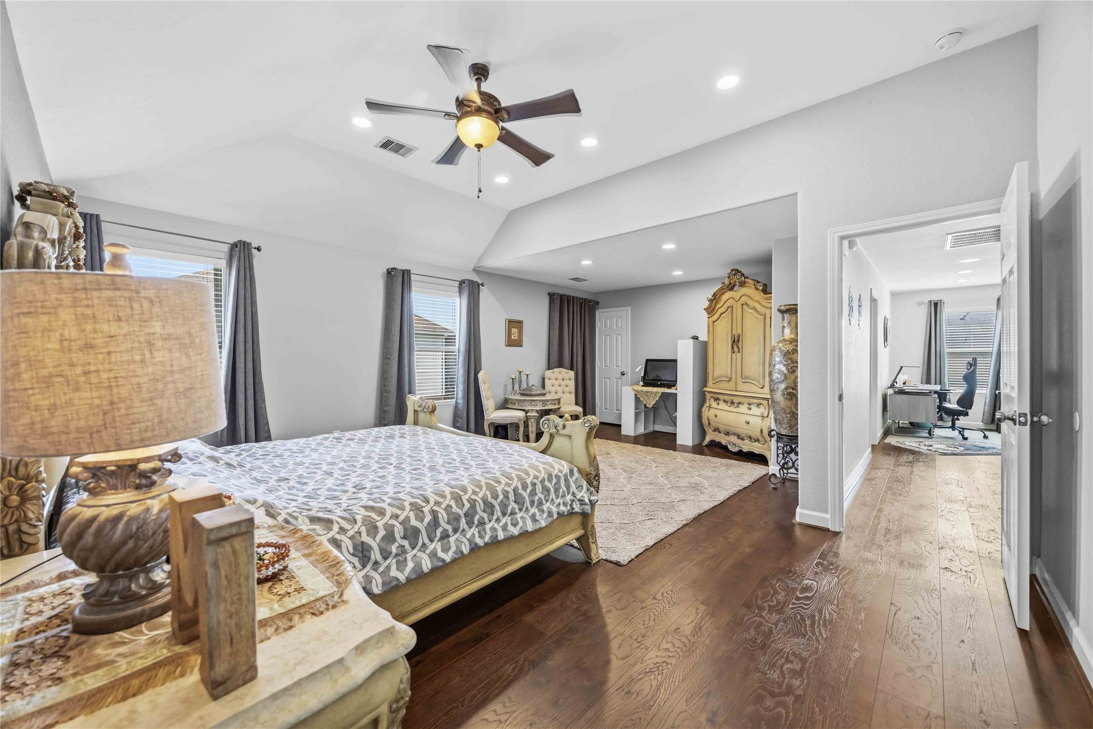19219 Brook Village Road Houston, TX 77084 - Photo 24 of 29 a spacious bedroom with a bed and ceiling fan