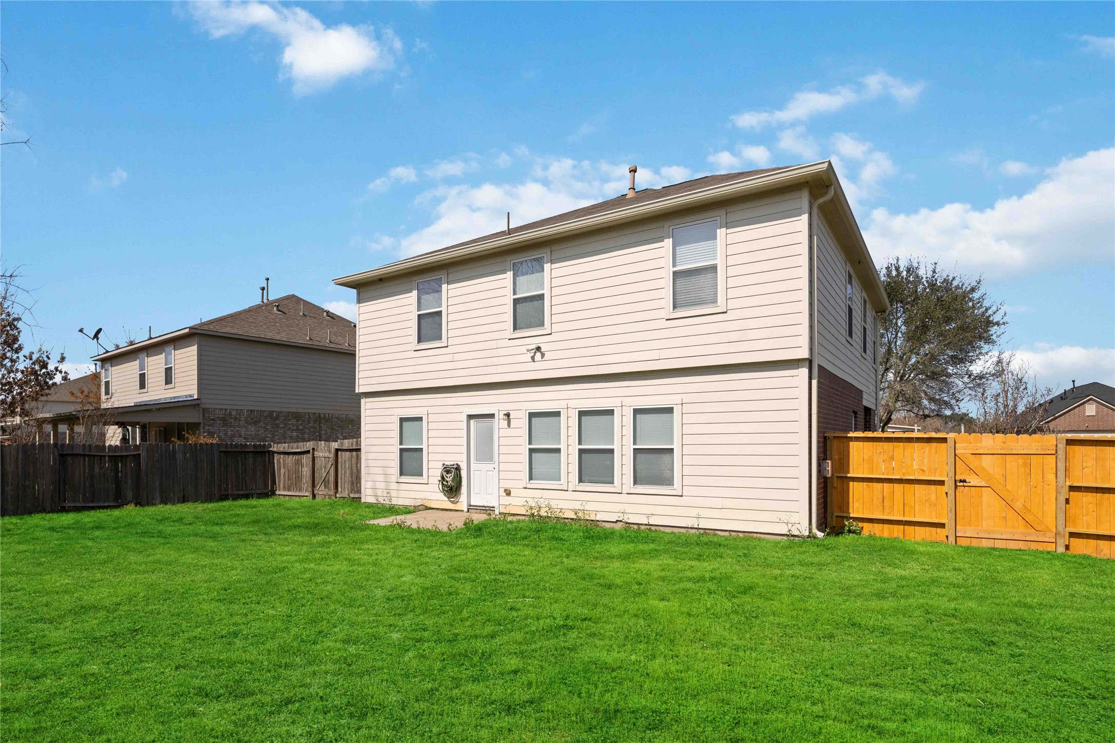 19219 Brook Village Road Houston, TX 77084 - Photo 29 of 29 a view of a house with a backyard