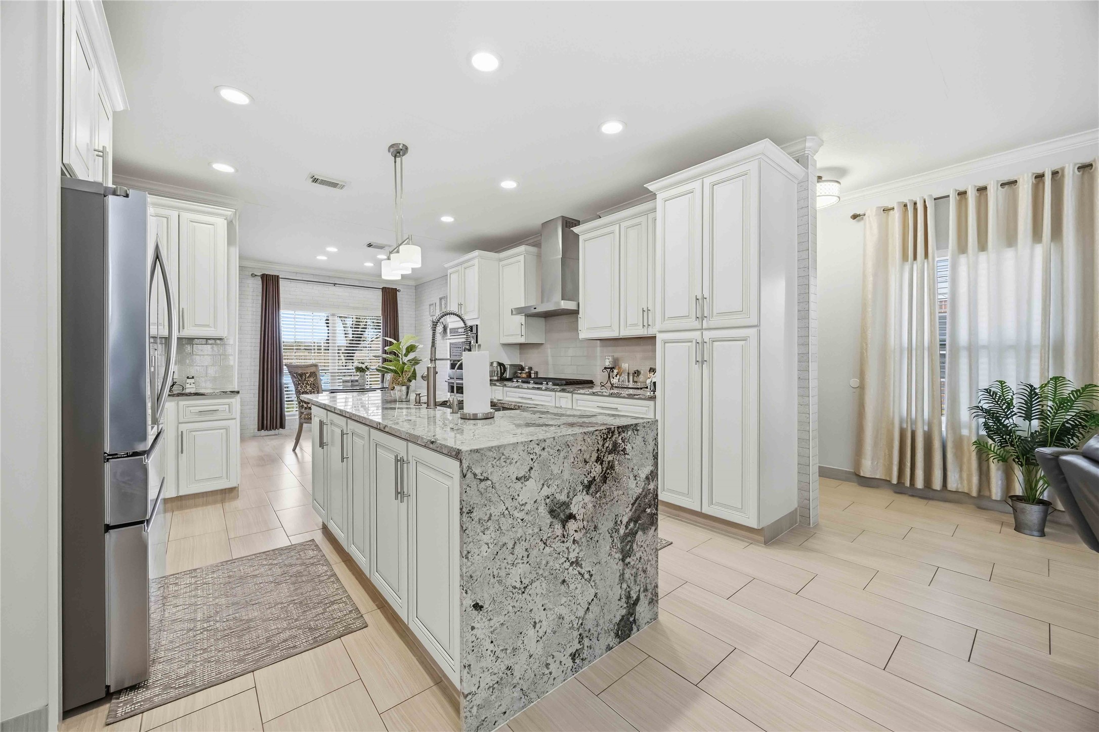 19219 Brook Village Road Houston, TX 77084 - Photo 5 of 29 a kitchen with stainless steel appliances kitchen island granite countertop a refrigerator and a sink