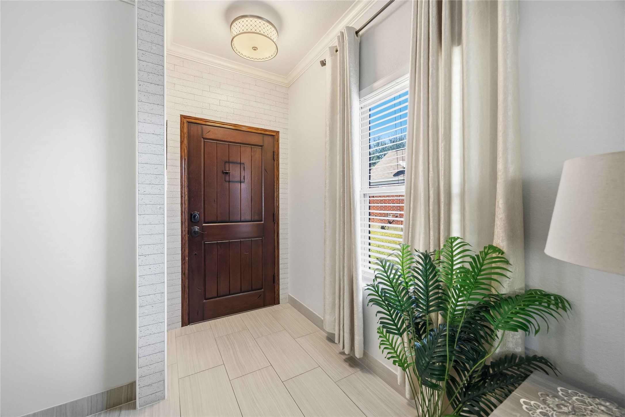 19219 Brook Village Road Houston, TX 77084 - Photo 7 of 29 a view of a hallway with wooden floor and a potted plant