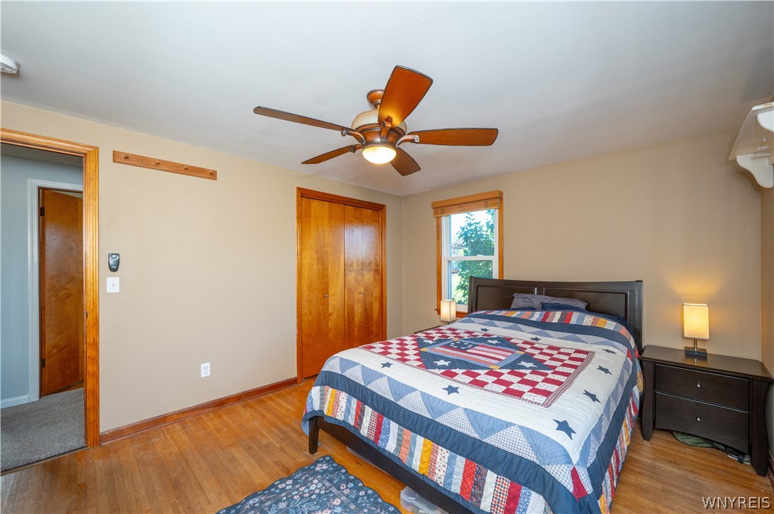 6463 Ward Road Sanborn, NY 14132 - Photo 24 of 49 Warm hardwood floors and natural wood trim ground this comfortable bedroom space.