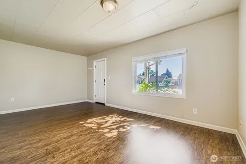 a view of an empty room with a painting on the wall