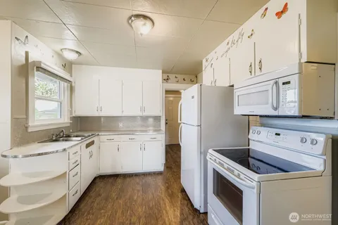 a kitchen with a stove a sink and a refrigerator