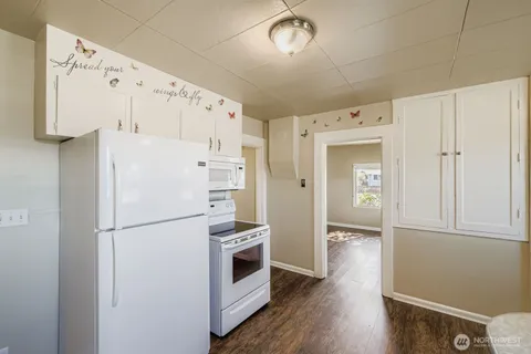 a white refrigerator freezer and a stove sitting inside of a kitchen
