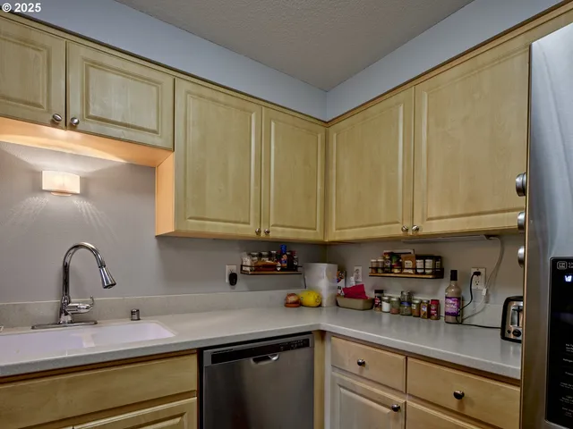 a kitchen with stainless steel appliances granite countertop a sink and cabinets