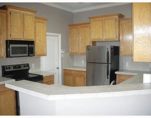 a kitchen with a refrigerator stove and microwave