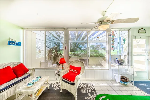a living room with furniture and a floor to ceiling window