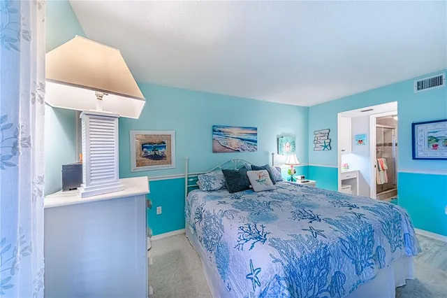 a bedroom with a bed and a lamp on table