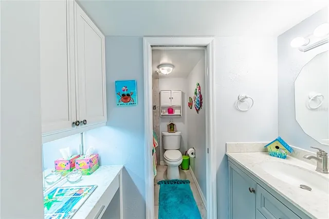 a bathroom with a sink mirror and vanity