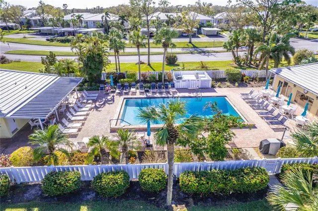 a view of swimming pool with outdoor seating and a garden