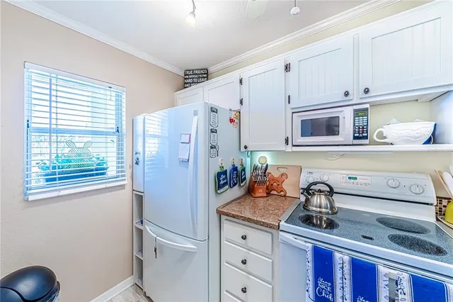 a kitchen with stainless steel appliances a refrigerator sink and cabinets