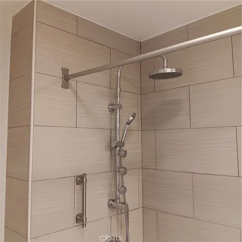 a white toilet sitting next to a shower