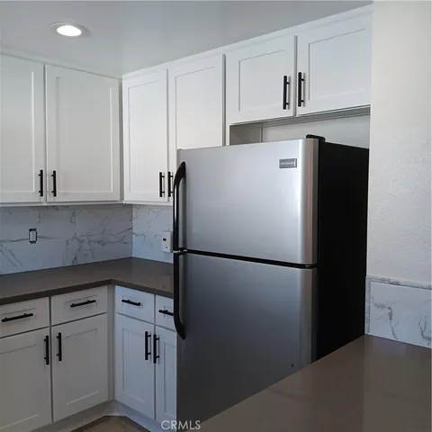a white refrigerator freezer sitting in a kitchen