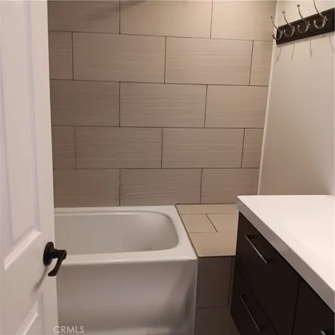 a kitchen with cabinets stainless steel appliances a sink and a stove