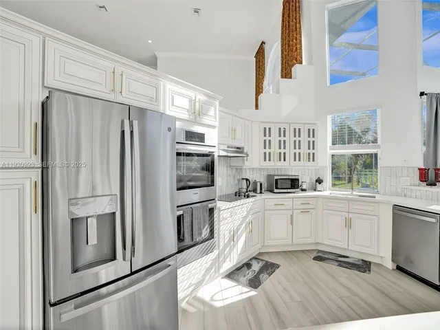 a dining room with furniture a chandelier and wooden floor