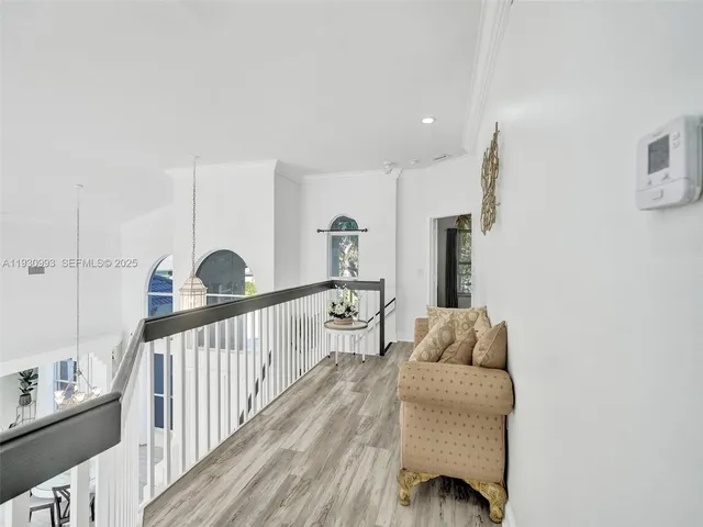 a bedroom with a bed couch and a large window