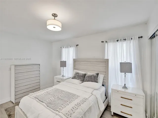 a bedroom with a bed and a lamp on table