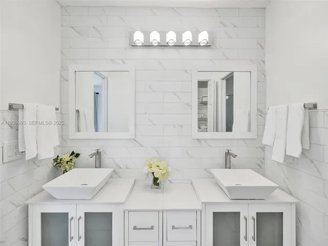 a view of a backyard with couches under an umbrella