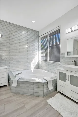 a bathroom with a sink toilet vanity and shower