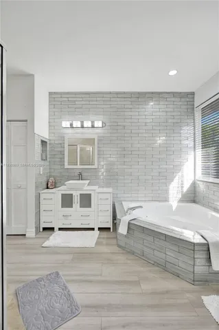 a view of a white house with a yard and large tree